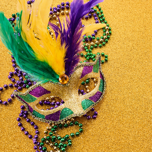 Gold Glitter background, Mardi Gras Mask adorned with purple, yellow, and green feathers, mardi gras beads