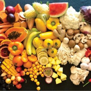 Large spread of brightly colored, healthy fruits and vegetables displayed on table