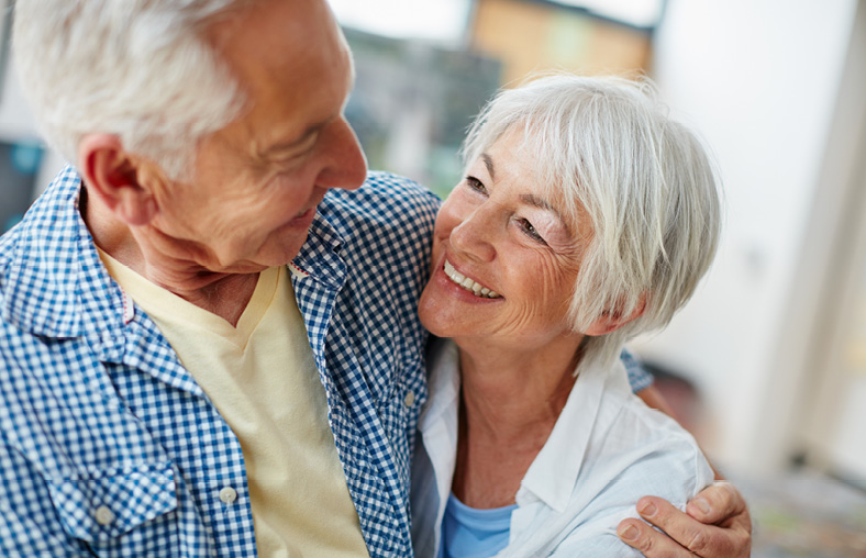 elderly couple smiling at each other