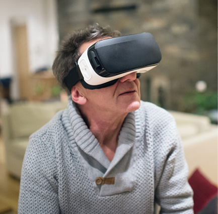 older gentleman wearing virtual reality goggles