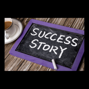 success story written on chalkboard with purple wood border