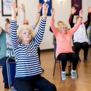 senior women doing exercises in stretching class